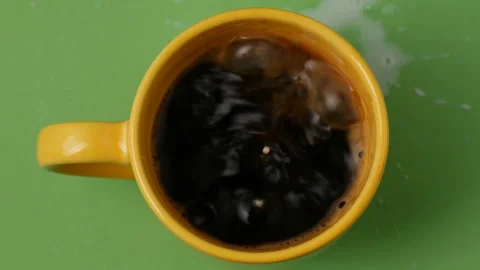 Pouring milk into a coffee cup 库存影片 162592822