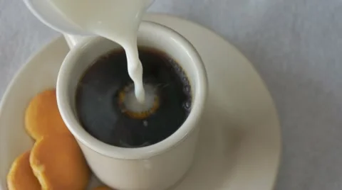 Pouring milk in coffee 스톡 동영상 10864358