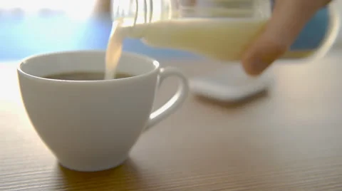 Pouring milk into coffee Stock-Footage 49213585