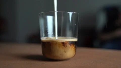 Pouring milk in to the coffee Stock Footage 158983225