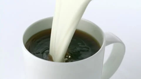 Pouring milk into coffee, Slow Motion Stock Footage