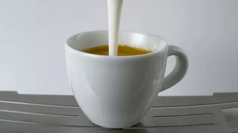 Pouring Milk Into Coffee Slowmotion Stock Footage 84059611