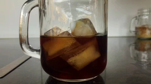 Pouring milk into cold brew coffee Stock Footage 127117419