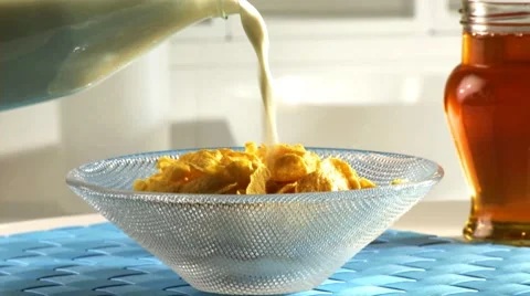 Pouring milk on cornflakes Stock Footage 8572659