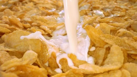 Pouring milk on cornflakes, macro shot Stock-Footage 113040683