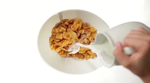 Pouring Milk on Cornflakes on white background Video stock 27117267