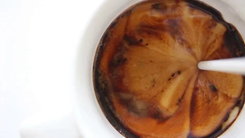 Pouring milk cream into coffee mug Stock Footage