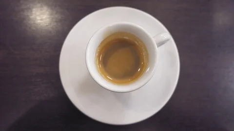 Pouring milk in a cup of coffee Video stock 72333809