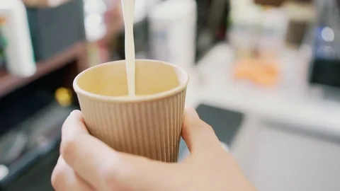 Pouring milk into a cup. Video stock 106329586