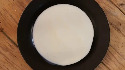 Pouring Milk onto a Dish MACRO Stock Footage 75605286