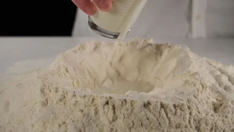 Pouring milk to flour Stock-Footage 205856564