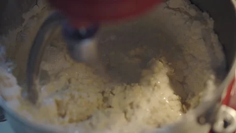Pouring Milk to Flour to make bread Stock-Footage 139409806