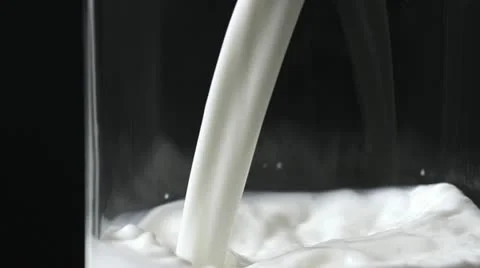 Pouring milk in the glass Stock Footage