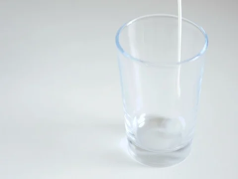 Pouring milk in a glass Stock Footage 84070104