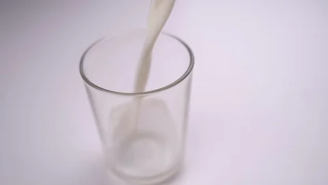 Pouring milk into a glass Stock Footage 123769660