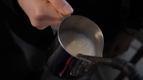 Pouring milk for making coffee  Video stock 125666375