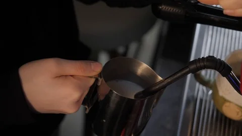 Pouring milk for making coffee  Stock Footage 125666520