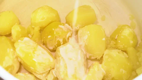 Pouring milk into mashed potatoes Stock Footage 249003603