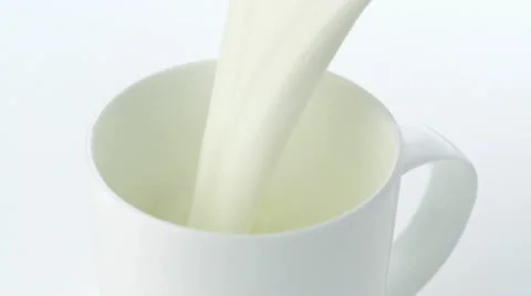 Pouring milk into mug, Slow Motion Stock Footage