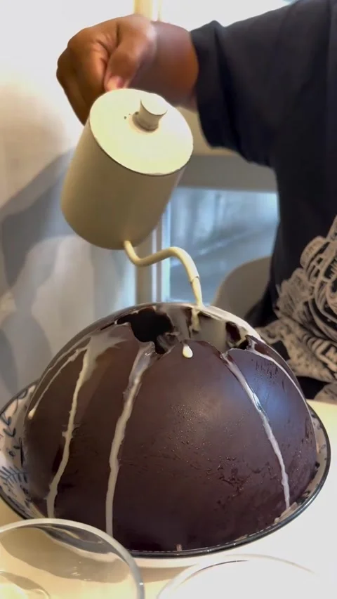 Pouring Milk Over a Large Dark Chocolate Dome Dessert Video stock 342264732