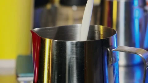 Pouring milk into a pitcher. Slow motion. Stock Footage 183969296