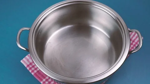 Pouring milk in a pot. Blue background 動画素材 110865313