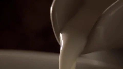 Pouring milk in slow motion Stock Footage 76100685