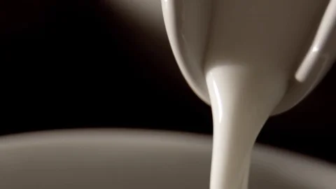 Pouring milk in slow motion Stock Footage 76100698