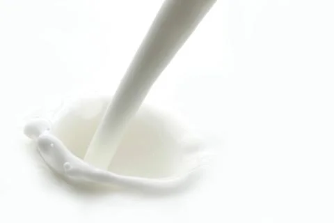 Pouring milk splash Stock Photos