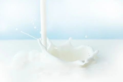 Pouring milk splash Stock Photos