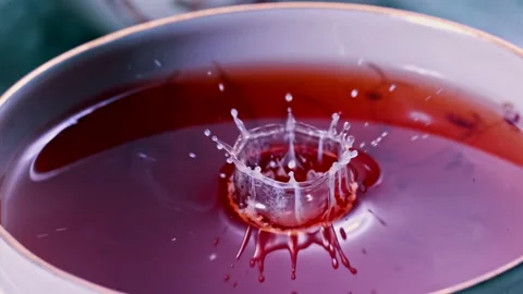 Pouring Milk in Tea Cup on the Table Super slow motion 1000fps Stock Footage 130982383