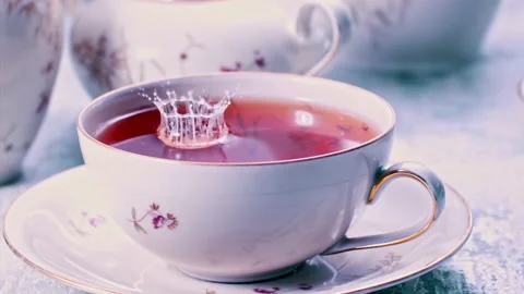 Pouring Milk in Tea Cup on the Table Super slow motion 1000fps Stock Footage 130983262