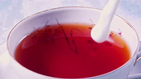 Pouring Milk in Tea Cup on the Table Super slow motion 1000fps Stock Footage 130986268