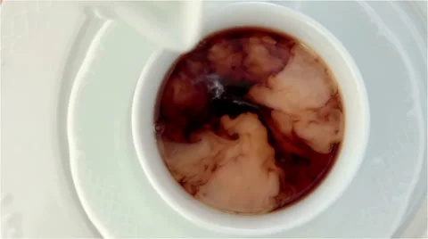 Pouring milk into tea Stock Footage 40617549