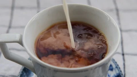 Pouring milk into tea. Stock Footage 148987524