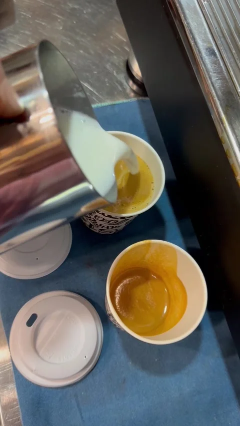 Pouring milk into two cups of coffee – cozy morning aesthetic Video stock 319398102