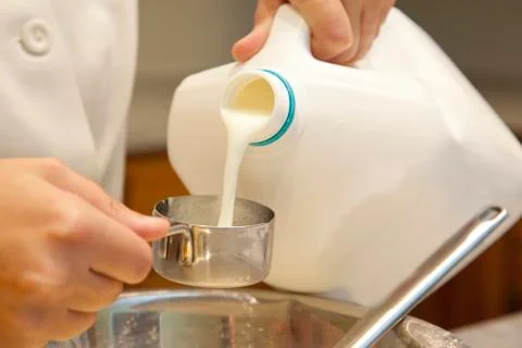 Pouring milk while baking Stock Photos