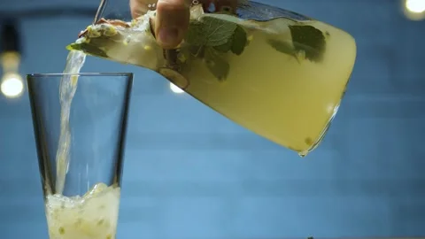 Pouring mint and passion fruit drink Stock Footage 143097467
