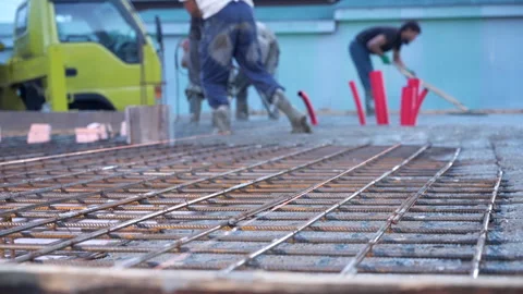 Pouring mixed concrete after installing steel reinforcement to create a house. Video stock 315819182