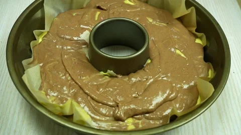 Pouring mixture into bundt cake pan. Stock Footage 233518743