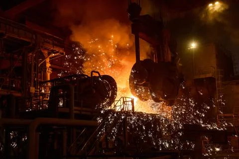 Pouring molten metal into a metallurgical electric arc furnace Stock Photos