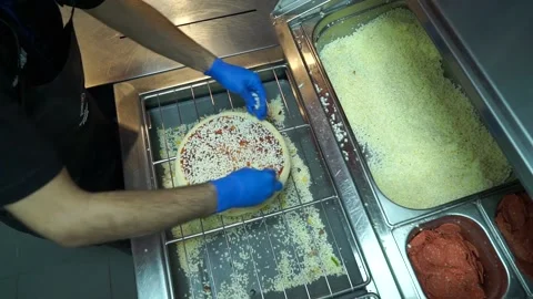 Pouring mozzarella cheese on pizza Stock Footage 187169537