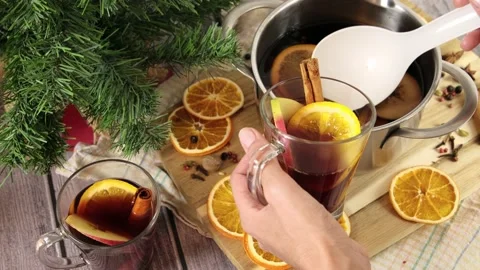 Pouring mulled wine in glasses with spoon, alcohol Christmas punch in pot. Hot Stock Footage 221766499