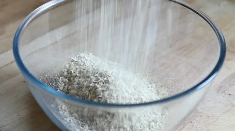 Pouring oats in a bowl Stock Footage