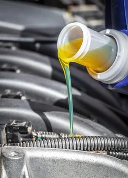 Pouring oil in the engine Stock Photos