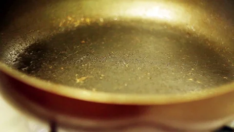Pouring oil into frying pan Stock-Footage 70631353