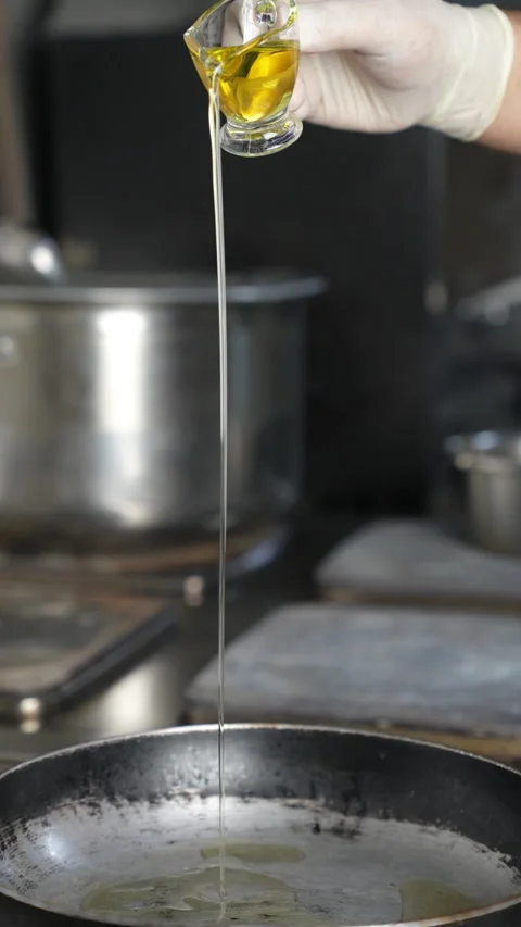 Pouring Oil into the Pan Stock Footage 296023451