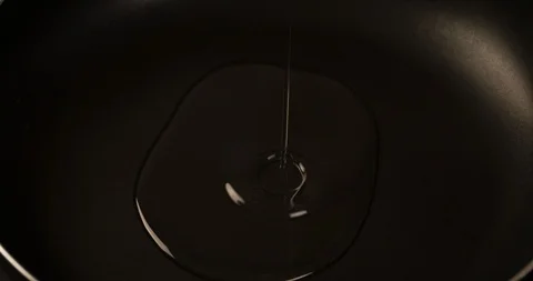 Pouring Oil in Pan surface closeup 4K Stock Footage 104061237