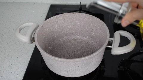Pouring olive oil in the kitchen.  Stock Footage 101154346