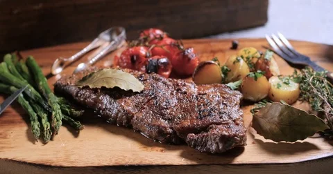 Pouring olive oil over a delicious sirloin steak Stock Footage